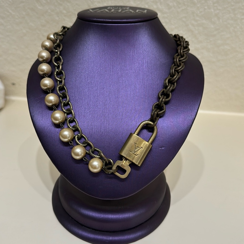 Pearl and fashion chain necklace with Louis Vuitton lock and key.